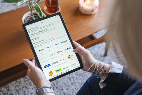 An image showing someone holding a tablet, displaying the Pension App other provider selection page.